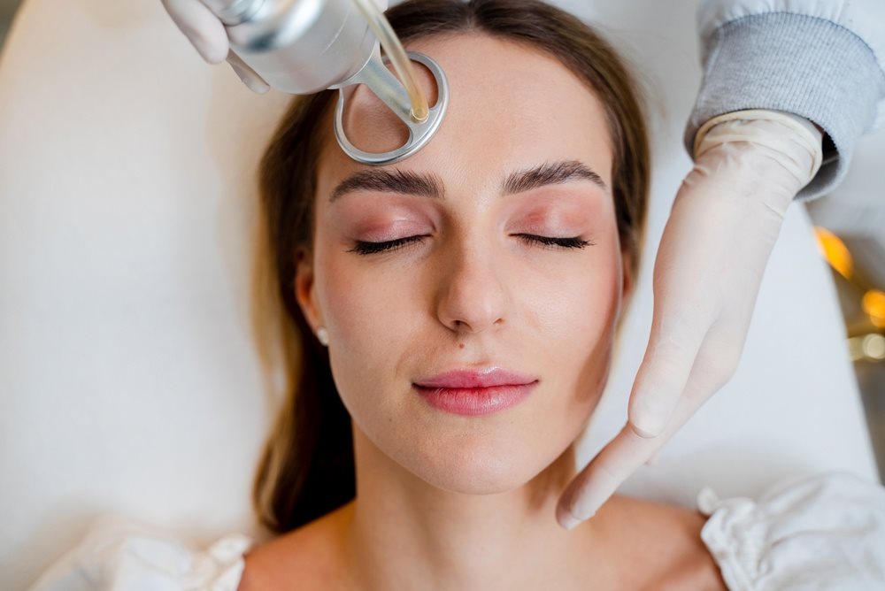 Laser skin rejuvenation handpiece on the forehead
